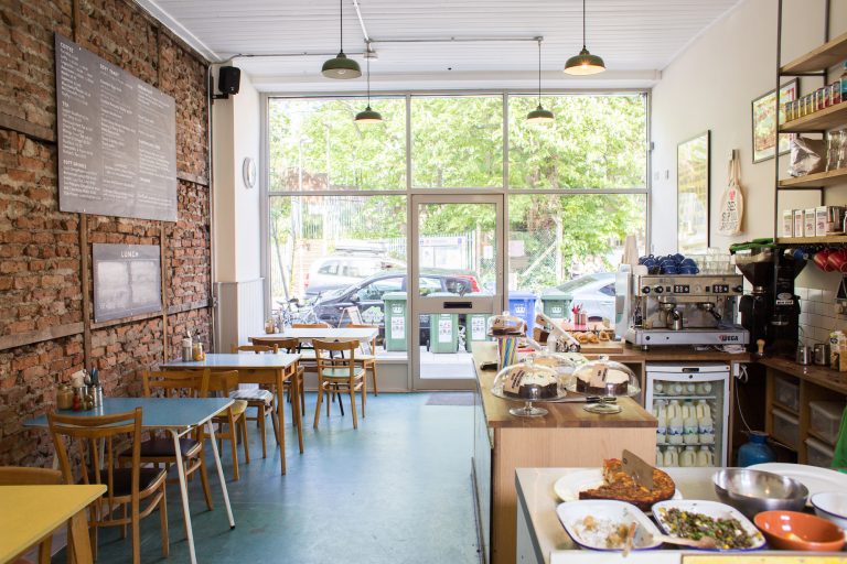 colourful bijou cafe with exposed brick wall and an attractive shop front - GREEN CAFE LONDON, SE13 - Shootfactory - QUIRKY & UNUSUAL LOCATIONS