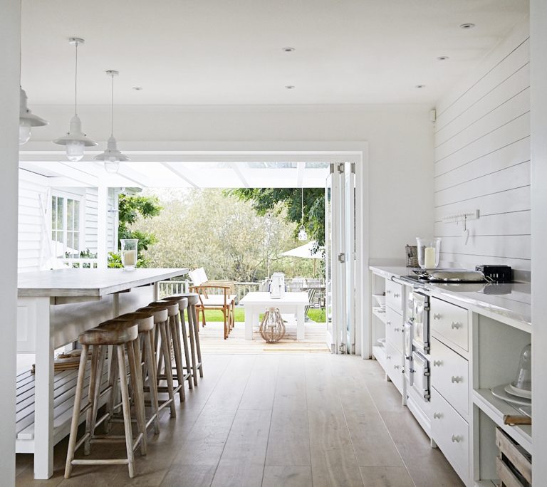 Kitchen with with white painted timber and bi-fold doors