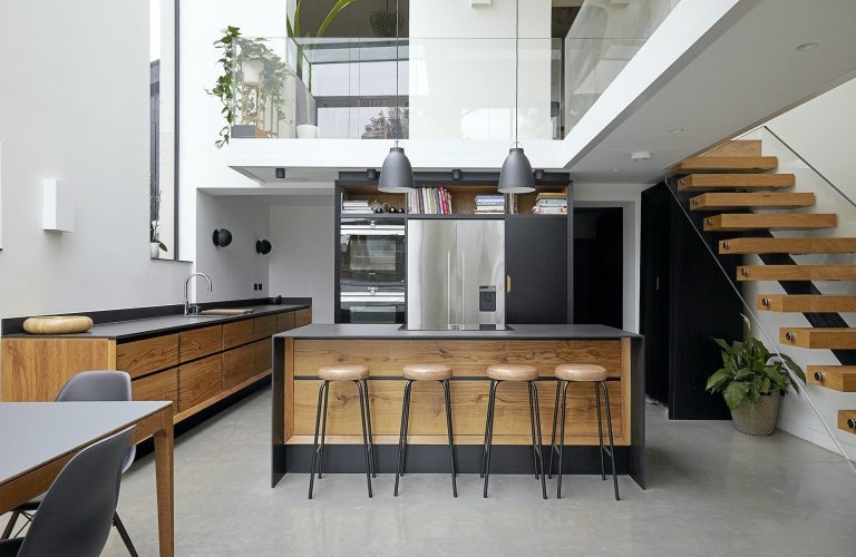 kitchen is made from tiger oak and walnut with black work surfaces / MONTGOMERY TWICKENHAM, TW1 - Location House - SHOOTFACTORY