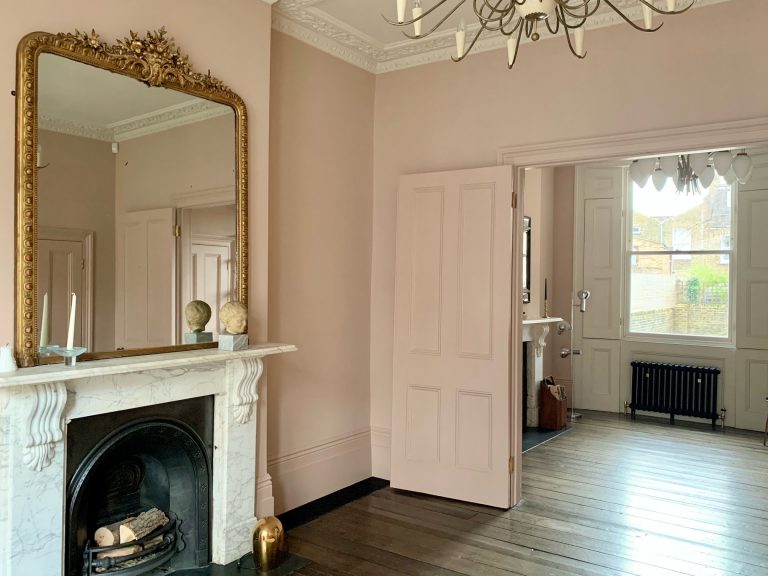 Pink sitting room with original open fire with doors leading into another room/BROOKE LONDON E5/Shootfactory/London location house