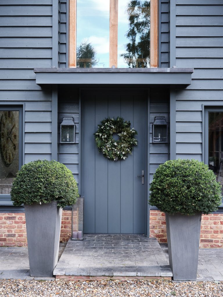BALCK PAITED FRONT DOOR AND TWO TOPIARY TREES - HAGUE BARN HENLEY ON THAMES, RG9 - SHOOTFACTORY - OTHER UK LOCATION HOUSE