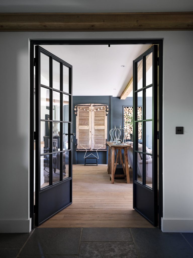 METAL FRAMED GLASS DOORS OPENING UP TO LOUNGE - HAGUE BARN HENLEY ON THAMES, RG9 - SHOOTFACTORY - OTHER UK LOCATION HOUSE