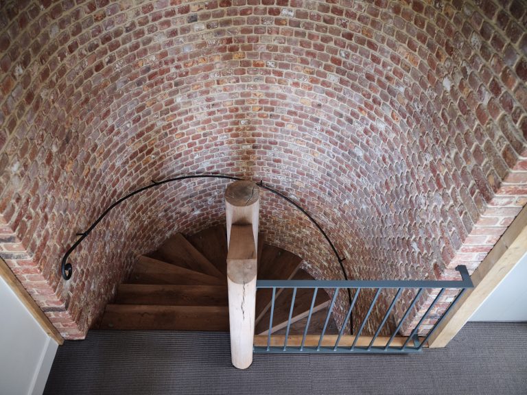 LOOKING DOWN STAIRCASE WITH EXPOSED CURVED BRICK WALL - HAGUE BARN HENLEY ON THAMES, RG9 - SHOOTFACTORY - OTHER UK LOCATION HOUSE